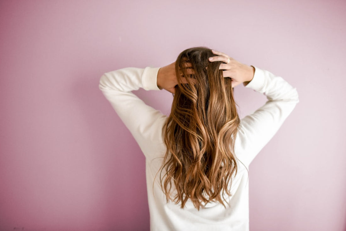 Woman with healthy hair showing black seed oil thymoquinone benefits for hair growth and wellness